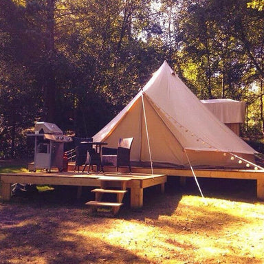 6 person tent Sibley 600 Protech Double Door on a wooden platform with BBQ and chairs in front
